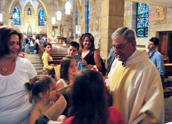 Members of St. Mary Parish in Lanesville surround their now-retired pastor, Father Harold Ripperger, after a May 17, 2008, Mass at the parish church that celebrated the 50th anniversary of his priestly ordination. Chuck and Leslie Lynch, members of St. Mary Parish, credit their former pastor with building up a strong culture of stewardship in the New Albany Deanery faith community. (Submitted photo)