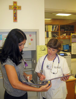 Marian University nursing student Sara Garrabrant, right, listens to advice from Stephanie Tooley, director of pediatrics, pediatric short stay and child life for St. Vincent Health. Garrabrant is a student in the accelerated online nursing education program that is a partnership between Marian University and St. Vincent Health. (Submitted photo)
