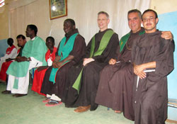 Franciscan Father Michael Perry, third from right, and two other members of the General Curia of the Order of Franciscan Minors visit the area of Omdurman, Khartoum, Sudan, in early July. The priests concelebrated Mass at a small Christian community center. More than 350 people attended the celebration. (Submitted photo)