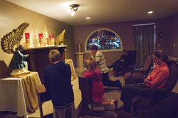 Kneeling in prayer before the Blessed Sacrament on Oct. 2 in the Good Shepherd Chapel at St. Mary (Nativity of the Virgin Mary) Parish in North Vernon are, from left, Zach Miller, Bailey Kilgore, Brock Leach and, partially obscured, Weston Miller. Seated, from left, are Mary Kilgore and Claudia Slabaugh. (Submitted photo/Missy Scarlett)