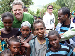 David Siler poses for a photo with children that he met during a recent visit to Ethiopia. As the director of Catholic Charities and Family Ministries for the archdiocese, Siler made the trip to witness the work of Catholic Relief Services in Africa. (Submitted photo)