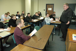 Father Robert Robeson, right, rector of Bishop Simon Bruté College Seminary in Indianapolis, teaches a class on Catholic beliefs and practices on Dec. 1 at Marian University in Indianapolis. Most of the students in the class are seminarians. Marian provides the intellectual formation for Bishop Bruté’s seminarians. Human, spiritual and pastoral formation for the seminarians takes place at the seminary. (Photo by Sean Gallagher)