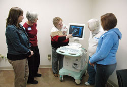 Eileen Hartman, center, shows an ultrasound machine on Jan. 7 at 1st Choice for Women to Jamie Wynberry, left, Anita Moody, Bobbie Lawless and Trish Funk, all nurses who are volunteering at the new crisis pregnancy center. It is an effort of the Gabriel Project, a parish-based, pro-life ministry active in many faith communities in central and southern Indiana. Hartman, a member of St. Bartholomew Parish in Columbus, is the executive director of the Gabriel Project. (Photo by Sean Gallagher)