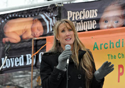 Respect Life Rally keynote speaker Rebecca Kiessling of Rochester Hills, Mich., an attorney and the mother of five children, shares her emotional pro-life story on Jan. 24 at Veterans’ Memorial Plaza in downtown Indianapolis. (Photo by Mary Ann Wyand)