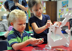 St. Susanna pre-kindergarten students Own Gessner, left, of Plainfield and Taryn Dempsey of Camby put a puzzle together on Aug. 18 at the Catholic school in Plainfield. (Photo by Mary Ann Wyand)