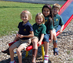 Phoebe Grote, left Bailey Lare, Aimee Corbin and Eric Frede, students at Pope John XXIII School in Madison, have fun on the school’s playground in this file photo from September 2009. (Submitted photo)