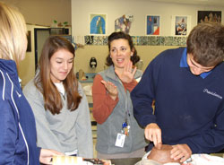 Art teacher Donna Burden, second from right, discusses elements of design with students, from left, Katelyn Koopman, Melina Cochran and Nathan Wimsatt during a class at Our Lady of Providence Jr./Sr. High School in Clarksville. (Submitted photo)