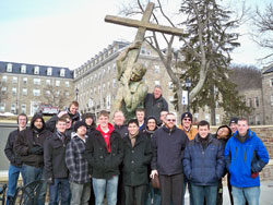 Seminarians enrolled at Bishop Simon Bruté College Seminary in Indianapolis pose on Jan. 21 in front of a statue of Bishop Bruté, the first bishop of Vincennes, on the campus of Mount St. Mary’s University and Seminary in Emmitsburg, Md. Father Robert Robeson, the rector of Bishop Bruté Seminary, stands next to the statue. Father Patrick Beidelman, center in the second row, is the vice rector of Bishop Bruté Seminary. (Submitted photo)