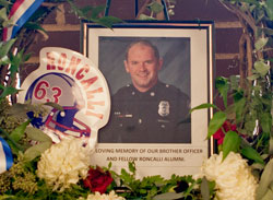 A memorial to Indianapolis Metropolitan Police Department officer David Moore is displayed in the front lobby of Roncalli High School in Indianapolis. A 2000 graduate of Roncalli High School, Moore died on Jan. 26 after being shot during a traffic stop three days earlier. (Photo by Jay Wetzel)