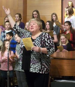 Choir members at Holy Family School in New Albany join Lori True in a performance of “A Place at the Table” on Feb. 2 at the parish church. A recording artist, True composed and recorded the musical piece that was chosen as the theme for the 2010-11 academic year at Holy Family School. True was invited to the school during Catholic Schools Week. (Submitted photo)