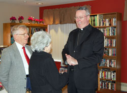 Paul and Beth Sullivan, members of St. Margaret Mary Parish in Westwood, Mass., say goodbye to their pastor, Bishop-designate Christopher J. Coyne, during a Feb. 13 reception at the Westwood Council on Aging in Westwood, Mass. (Submitted photo)