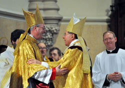 Archbishop Daniel M. Buechlein embraces the newly ordained Bishop Christopher Coyne during the historic Mass at St. John the Evangelist Church in downtown Indianapolis on March 2. (Photo by Mary Ann Wyand)