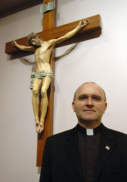 Father Vincent Lampert, the pastor of SS. Francis and Clare of Assisi Parish in Greenwood, poses on March 10 in his parish’s church. Since 2005, Father Lampert has also been the exorcist of the Archdiocese of Indianapolis. In this ministry, he has ministered to people in central and southern Indiana and beyond. (Photo by Sean Gallagher)