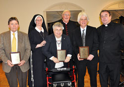 Msgr. Joseph Schaedel, center, and Servants of the Gospel of Life Sister Diane Carollo, second from left, pose for a photograph with archdiocesan Sanctity of Life Award recipients, from left, Our Lady of the Most Holy Rosary parishioner Jerry Mattingly of Indianapolis, St. Mark the Evangelist parishioner Diane Komlanc of Indianapolis, St. Patrick parishioner Tom McBroom of Terre Haute and Father Glenn O’Connor, the pastor of St. Ann and St. Joseph parishes in Indianapolis, after the March 3 awards dinner. (Photo by Mary Ann Wyand)