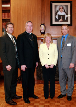 David Siler, executive director of the archdiocesan Secretariat for Catholic Charities and Family Ministries, left; Bishop Christopher J. Coyne, auxiliary bishop and vicar general of the archdiocese; Dottie King, president of Saint Mary-of-the-Woods College; and John Etling, agency director for Catholic Charities Terre Haute, are pictured on April 27 after announcing a unique scholarship partnership between Saint Mary-of-the-Woods and Catholic Charities Terre Haute. (Submitted photo)