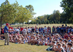 As the executive director of the archdiocese’s Catholic Youth Organization, Ed Tinder talks to the runners who competed in the CYO Cross Country Meet in Indianapolis in October of 2010. (Submitted photo)
