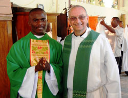 Father Thomas Clegg, right, pastor of St. Augustine and Most Sacred Heart of Jesus parishes, both in Jeffersonville, and Father Lesly DesHommes, a priest of the Archdiocese of Cap Hatien in Haiti, are pictured in February of 2011 after Father DesHommes’ ordination to the priesthood. Father DesHommes is one the first seminarians that the Jeffersonville parishes sponsored. This photograph was taken after his first Mass at St. Raphael Parish, the Jeffersonville parishes’ sister parish in Haiti. (Submitted photo)