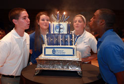 Bishop Chatard High School students Nick Shultz, from left, Monica Ward, Lauren Taylor and Okenna Oruche blow out the candles on a cake celebrating the Indianapolis North Deanery archdiocesan high school’s 50th anniversary on Sept. 13. (Submitted photo)