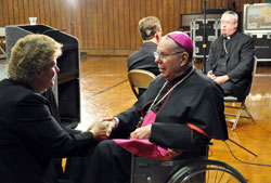 Jackie Byers, left, speaks to Archbishop Emeritus Daniel M. Buechlein after a press conference announcing his retirement on Sept. 21. Byers, a member of St. Simon the Apostle Parish in Indianapolis, is past president of the Archdiocesan Finance Council. Bishop Christopher J. Coyne, right, the archdiocese’s new apostolic administrator, talks with Kevin Rader, a reporter for WTHR Channel 13 in Indianapolis. (Photo by Mary Ann Garber)
