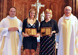 Victoria Nondorf, a member of St. Pius X Parish in Indianapolis, second from left, displays the 2011 Our Lady of Guadalupe Pro-Life Youth Award, and Dianna Meinecke, a member of St. Mary Parish in Navilleton, second from right, holds the 2011 Archbishop Edward T. O’Meara Respect Life Award following the archdiocesan Respect Life Sunday Mass on Oct. 2 at SS. Peter and Paul Cathedral in Indianapolis. Posing with Victoria and Meinecke are Father Peter Marshall, left, associate pastor of St. Pius X Parish, and Msgr. Joseph Schaedel, pastor of St. Luke the Evangelist Parish in Indianapolis and principal celebrant of the annual pro-life liturgy. (Photo by Sean Gallagher)