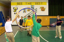 Two boys hold up hula hoops during a physical education class on Sept. 26 for third-grade students at St. Patrick School in Terre Haute. Standing behind the hula hoops are, from left, Andrew Wilson, Matthew Graham, Dylan Major, Nate Givan and Jorjia Hancock. (Submitted photo)