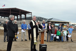 Bishop Christopher J. Coyne, apostolic administrator, reflects on the new school building being constructed for St. Mary School in Greensburg on Sept. 27. At his left is Father John Meyer, pastor of St. Mary Parish in Greensburg. Bishop Coyne, parish leaders, parishioners, school faculty and students, and leaders in the architectural firm and construction company who designed and are building the new facility were on hand for an event to celebrate the progress made thus far on the $8 million project. (Photo by Sean Gallagher)
