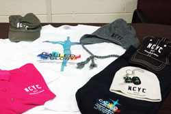 T-shirts, polo shirts, hooded sweatshirts, several varieties of hats, dog tags and key chains are among the many items being sold for the National Catholic Youth Conference being held on Nov. 17-19 in Indianapolis. Souvenir items are available through the conference’s website at www.ncyc.nfcym.org. Click on “NCYC Gear” at the top of the website’s first page to shop for souvenirs. (Photo by John Shaughnessy)