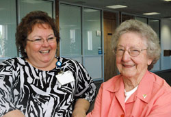 Nearing her 90th birthday, Kathryn Massing, right, continues to add to her 28 years and 35,000 hours of volunteer service at Franciscan St. Francis Health–Beech Grove. Here, she enjoys time with Sherri Walker, director of service excellence and volunteer services for the hospital. (Photo by John Shaughnessy)