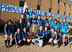 Members of the girls’ soccer team at Our Lady of Providence Jr./Sr. High School in Clarksville show their joy and their trophy after winning the Class A state championship on Oct. 29. It is the first time in the 60-year history of the school that a Providence team has won an Indiana High School Athletic Association state championship in a team sport. (Submitted photo)