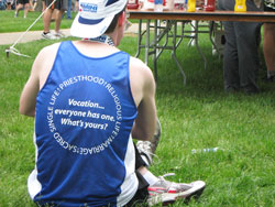 Wearing a team jersey, a member of the Race for Vocations team rests after completing the OneAmerica 500 Festival Mini-Marathon on May 8, 2010, in Indianapolis. The Race for Vocations team is gearing up for what will be its fifth participation in the Mini-Marathon and the Finish Line 500 Festival 5K, which will take place on May 5, 2012. (Submitted photo)