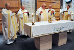 Father Gerald Kirkhoff, center, vicar of the archdiocesan Vicariate for Advocacy for Priests, leads the eucharistic prayer as the principal celebrant for a memorial Mass celebrated on Nov. 22 at the Calvary Cemetery Chapel in Indianapolis to honor deceased bishops and priests that served the Church in central and southern Indiana. Concelebrating the Mass were, from left, Father Paul Landwerlen, Father Larry Crawford, Msgr. Frederick Easton and Father Sean Danda. (Photo by Mary Ann Garber)