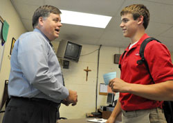 Deacon candidate Tom Horn, a religion teacher at Roncalli High School in Indianapolis, talks with sophomore Luke Jahnke, a member of St. Jude Parish in Indianapolis, on Nov. 16, 2011. (Photo by Sean Gallagher)