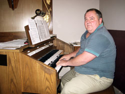Lifetime St. Maurice parishioner Mark Wirth of Napoleon has played the organ at Masses for 40 years. He praises the parishioners for singing joyfully during liturgies in their historic church. (Submitted photo)