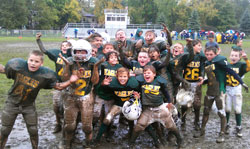 The pure joy of boys getting to play football in the mud radiates from the faces of the fifth- and sixth-grade players on the football team of Our Lady of the Greenwood Parish in Greenwood. (Submitted photo)