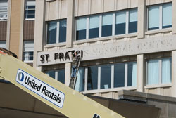 As the end of the week arrived for consolidating clinical services, workers were busy removing external signage at Franciscan St. Francis Health’s hospital in Beech Grove. (Submitted photo)