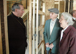 In this file photo from 2008, Archbishop Daniel M. Buechlein talks in the home of Cardinal Joseph E. Ritter with Frank and Margaret Lori, members of St. Anthony of Padua Parish in Clarksville. The Loris are the parents of Bishop William E. Lori. Bishop Lori grew up in New Albany. On March 20, Pope Benedict XVI appointed him to be the 16th archbishop of Baltimore. (File photo by Sean Gallagher)