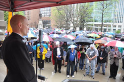 Father John Hollowell, left, chaplain of Cardinal Ritter Jr./Sr. High School in Indianapolis and associate pastor of St. Malachy Parish in Brownsburg, speaks on March 23 during the “Stand Up for Religious Freedom” rally on the grounds of the Indiana Statehouse in Indianapolis. (Photo by Sean Gallagher)