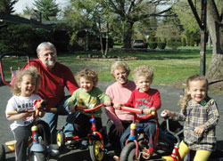Married for 42 years, Fred and Doris Chandler have experienced an unexpected blessing in their spiritual lives by helping to care for four children—a set of triplets that were born seven weeks prematurely and their baby brother. The Chandlers are pictured with Addy, left, Drew, Alex and Clara, the children of Aaron and Maribeth Smith. (Photo by John Shaughnessy)