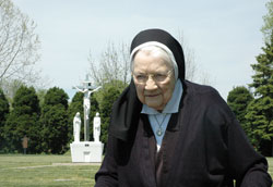 As she nears her 100th birthday on May 13, Benedictine Sister Mary Sylvester Will continues to take daily walks to the cemetery at Our Lady of Grace Monastery in Beech Grove, where she says she talks with her friends who have died and prays for those who are living. (Photo by John Shaughnessy)