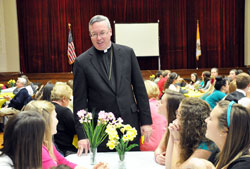 Bishop Christopher J. Coyne, apostolic administrator, talks with peer mentors during the A Promise to Keep: God’s Gift of Human Sexuality luncheon on April 23 at the Archbishop O’Meara Catholic Center in Indianapolis. The abstinence education program is administered by Margaret Hendricks and Sylvia Brunette, staff members of the archdiocesan Office of Catholic Education. (Photos by Mary Ann Garber)
