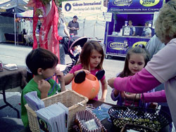 Patty Watson, a member of Our Lady of Perpetual Help Parish in New Albany, talks on Oct. 9, 2011, with, from left, Evan and Lauren McCombs, also parishioners, and another visitor to a booth sponsored by the parish that was part of New Albany’s annual “Harvest Homecoming” Festival. The booth was organized by Our Lady of Perpetual Help’s Committee on Evangelization. Evan and Lauren are, respectively, in kindergarten and the second-grade at Our Lady of Perpetual Help School. (Submitted photo)
