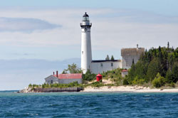 The lighthouse on South Manitou Island is visible across the choppy water of Lake Michigan. Scenic hiking trails on the eight-square-mile south island lead to the lighthouse, as well as a shipwreck, grove of giant cedars and high dune bluffs. (Photo by Mary Ann Garber)