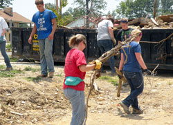 High school students on the archdiocese’s Homeland Mission project on June 24-29 help clear debris left by the tornadoes that devastated the southern Indiana community of Henryville on March 2. (Submitted photo)