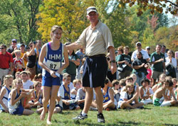 Smiles, sunshine and snapshots mark the festivities following the Catholic Youth Organization’s All-City Cross Country meet in 2011. CYO executive director Ed Tinder congratulates Katherine Free, a runner from Immaculate Heart of Mary Parish in Indianapolis, during the post-race celebration. (Submitted photo/Kent Hughes)