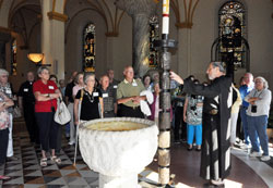 Benedictine Brother Maurus Zoeller, guest house manager and director of retreat programs, gives a tour of Saint Meinrad Archabbey’s Church of Our Lady of Einsiedeln in St. Meinrad on Aug. 6 for pilgrims participating in the archdiocesan summer pilgrimage. The pilgrims also visited Monastery Immaculate Conception, the home of the Sisters of St. Benedict, in Ferdinand, Ind., and Abbey of Gethsemani in Trappist, Ky., during the three-day pilgrimage. (Photo by Mary Ann Garber)