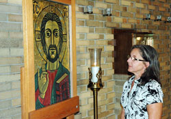 Cathy Dearing says a prayer before an icon of Jesus in the chapel of Our Lady of Fatima Retreat House in Indianapolis. Dearing takes several retreats a year at Fatima, saying they draw her closer to God, friends and family. (Photo by John Shaughnessy)