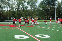 Members of the football team of Cardinal Ritter High School in Indianapolis practice on the school’s new multi-sport athletic field on Sept. 12. The field is a source of pride for the Cardinal Ritter community. (Photo by John Shaughnessy)
