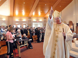 Bishop Christopher J. Coyne, apostolic administrator, blesses members of the congregation at the conclusion of the March 25 Mass of Dedication at the new St. Mary-of-the-Knobs Church in Floyd County. Bishop Coyne has now led the Church in central and southern Indiana for more than a year since the Sept. 21, 2011, resignation of Archbishop Emeritus Daniel M. Buechlein. (File photo by Mary Ann Garber)