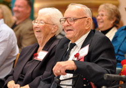 St. Gabriel parishioners Robert and Wannetta Hilbert of Connersville laugh at a joke by Bishop Christopher J. Coyne, apostolic administrator, during his homily for the 29th annual archdiocesan Golden Jubilee Mass for longtime married couples on Sept. 23 at SS. Peter and Paul Cathedral in Indianapolis. The Hilberts have been married for 72 years. He is 96 and she is 93. (Photo by Mary Ann Garber)
