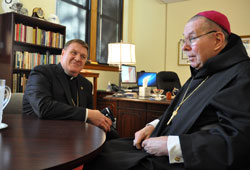 Archbishop Joseph W. Tobin, left, meets Archbishop Emeritus Daniel M. Buechlein in the chancery at the Archbishop Edward T. O’Meara Catholic Center in Indianapolis on Oct. 18. (Photo by Sean Gallagher)